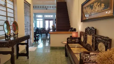 a living room with chairs and a table and stairs at MY CHINAMAN'S HOME II in George Town