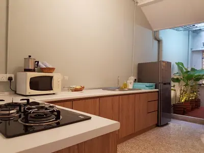 a kitchen with a stove and a microwave at MY CHINAMAN'S HOME II in George Town