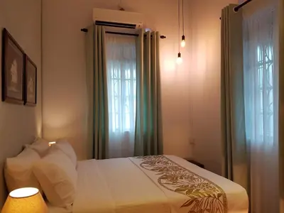 a bedroom with a bed and a window at MY CHINAMAN'S HOME II in George Town