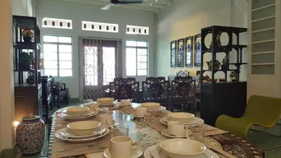 a dining room with a table with china on it at MY CHINAMAN'S HOME II in George Town
