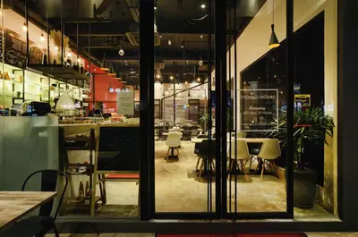 a restaurant with a table and chairs in a room at Chariton Hotel Alma in Bukit Mertajam