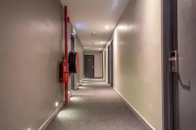 a corridor of a hallway with a long hallway at Chariton Hotel Alma in Bukit Mertajam