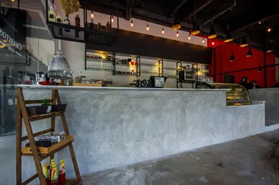 a concrete counter in a room with a kitchen at Chariton Hotel Alma in Bukit Mertajam