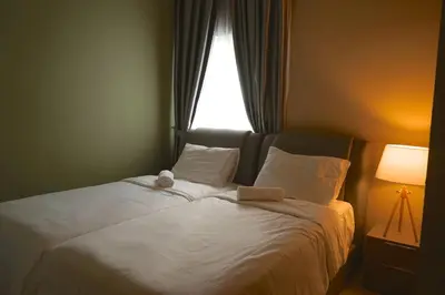 a bed in a bedroom with a window at The Majestic Ipoh by The Osborne in Ipoh