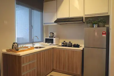 a kitchen with a refrigerator and a microwave at The Majestic Ipoh by The Osborne in Ipoh