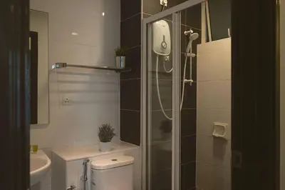 a bathroom with a shower and a toilet and a sink at The Majestic Ipoh by The Osborne in Ipoh