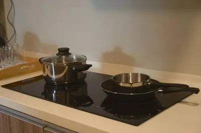 a stove top with two pots and pans on it at The Majestic Ipoh by The Osborne in Ipoh