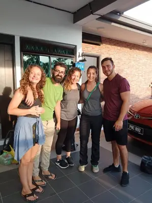 a group of people standing in front of a store at Austin GuestHouse in Ipoh