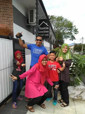 a group of people standing in front of a building at Austin GuestHouse in Ipoh