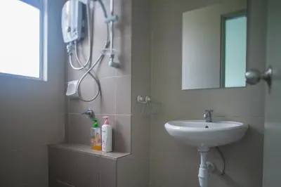 a bathroom with a sink and a shower at Strawberry Homestay in Cameron Highlands