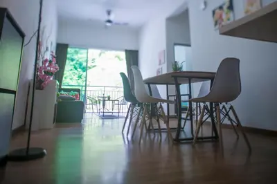 a table and chairs in a room with a balcony at Strawberry Homestay in Cameron Highlands