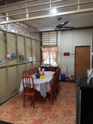 a dining room with a table with chairs and a tableablish at Teratak Opah Kamunting in Taiping
