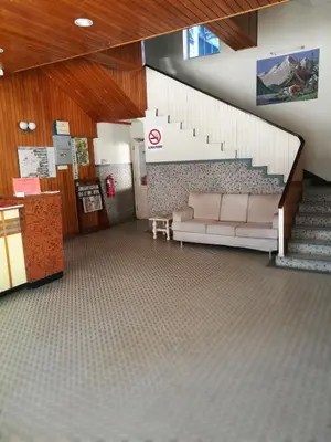 a lobby with a couch and stairs in a building at New Caspian Hotel in Ipoh