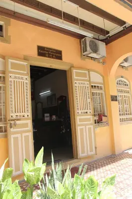 an open door to a building with plants at Old Penang Hotel - Trang Road in George Town