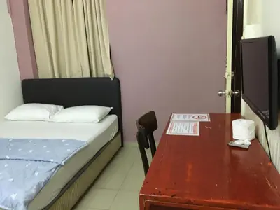 a small room with a bed and a table at Old Penang Hotel - Trang Road in George Town