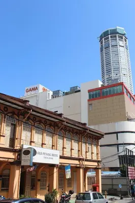 a building on a city street with a tall building at Old Penang Hotel - Trang Road in George Town