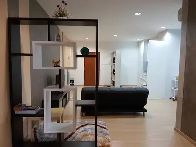 a living room with a black couch and a mirror at 118 Suite in George Town
