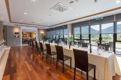 a large dining room with a long table and chairs at Meru Suites at Meru Valley Resort in Ipoh