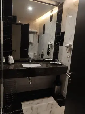 a bathroom with a sink and a mirror at Purest Hotel Sungai Petani in Sungai Petani