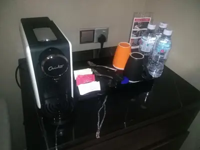 a camera sitting on a table with bottles of water at Purest Hotel Sungai Petani in Sungai Petani