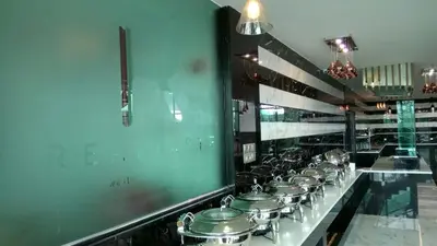 a kitchen with a line of pots and pans at Purest Hotel Sungai Petani in Sungai Petani