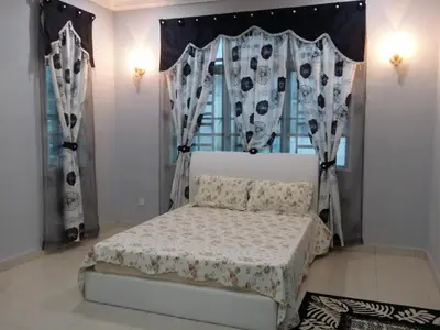 a bedroom with a bed and a window with curtains at The Louvre Moslim Homestay Sungai Petani in Sungai Petani