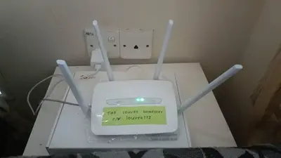 a router with a sign on it sitting on a table at The Louvre Moslim Homestay Sungai Petani in Sungai Petani