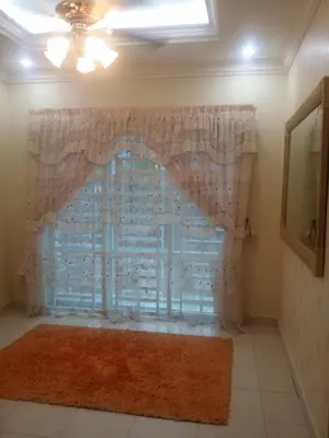 a window with a curtain and a rug at The Louvre Moslim Homestay Sungai Petani in Sungai Petani