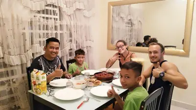 a group of people sitting around a table eating food at The Louvre Moslim Homestay Sungai Petani in Sungai Petani