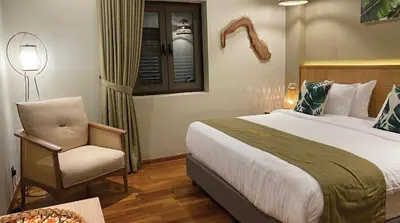a hotel room with a bed and a chair at ke-lan-tan House in George Town