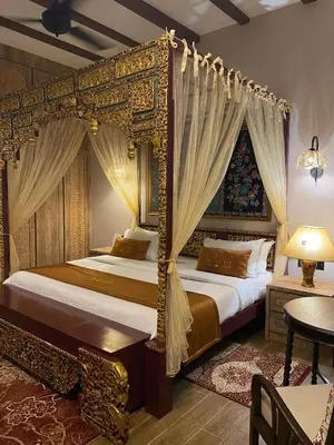 a bedroom with two beds and a canopy bed at ke-lan-tan House in George Town