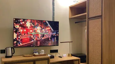 a flat screen tv hanging on a wall at ke-lan-tan House in George Town