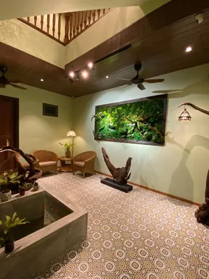 a living room with a large aquarium on the wall at ke-lan-tan House in George Town