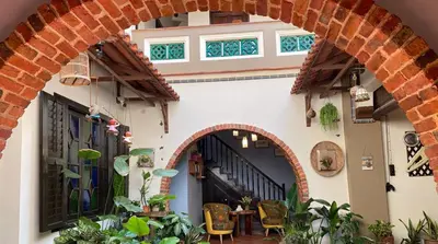 an archway in a building with a table and chairs at ke-lan-tan House in George Town