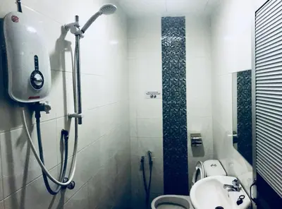 a bathroom with a shower and a toilet and a sink at Lunas Bliss in Lunas