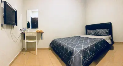 a bedroom with a bed and a desk and a television at Lunas Bliss in Lunas