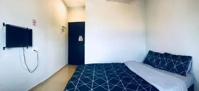a bedroom with a blue bed and a tv at Lunas Bliss in Lunas