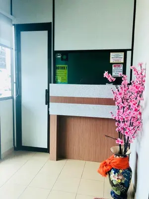 a vase with pink flowers in it in a lobby at Lunas Bliss in Lunas