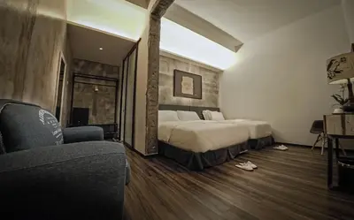 a hotel room with a bed and a couch at Merton Hotel Ipoh in Ipoh