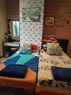two twin beds in a room with a piano at The Mons inside Tower Regency Hotel and Apartments in Ipoh