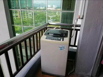 a small machine in a balcony with a window at The Mons inside Tower Regency Hotel and Apartments in Ipoh