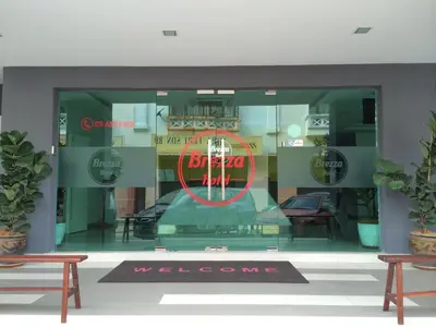 a window of a store with a sign in it at Brezza Hotel Lumut in Lumut