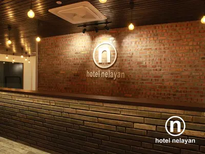 a brick wall with a hotel malayan sign on it at Hotel Nelayan in Pangkor