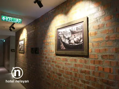a brick wall with a picture on it at Hotel Nelayan in Pangkor