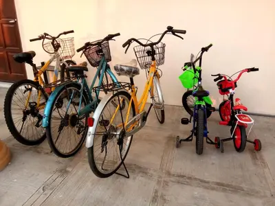 a group of bikes parked next to a wall at Kurau Inn Boutique Farmstay in Kuala Kurau