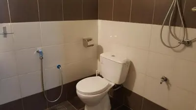 a bathroom with a toilet and a shower at Kurau Inn Boutique Farmstay in Kuala Kurau