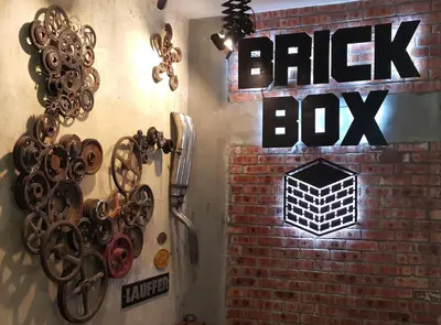 a brick wall with a sign that reads entry box at Brick Box Hotel @ Oldtown Ipoh in Ipoh