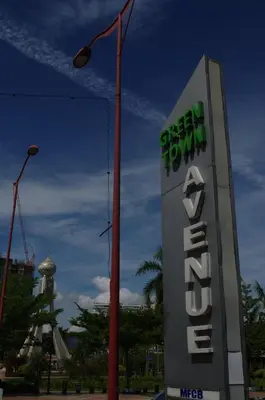a sign for the greenland turn inn with a street light at Hotel Cheqinn in Ipoh