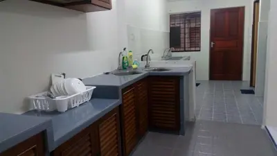 a kitchen with two sinks and a counter top at Taiping Vacation Homestay in Taiping
