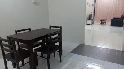 a black table and chairs in a room at Taiping Vacation Homestay in Taiping